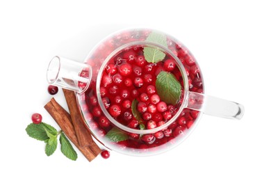 Photo of Tasty hot cranberry tea with mint and cinnamon in teapot on white background, top view