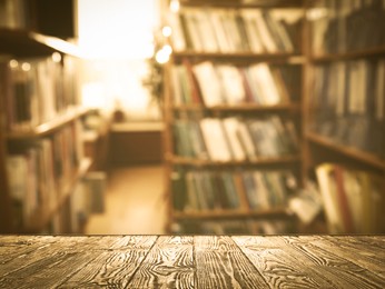 Image of Empty wooden table in library. Space for design 