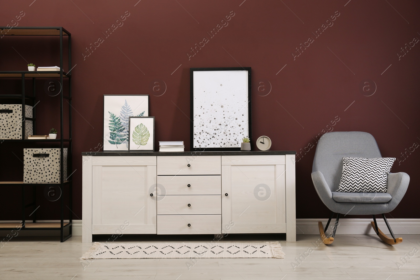 Photo of Modern room interior with chest of drawers near brown wall