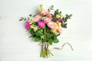 Photo of Bouquet of beautiful fragrant flowers on wooden background