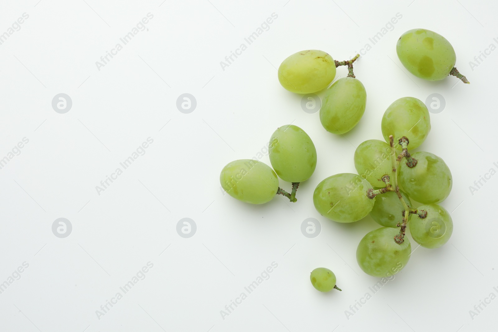 Photo of Fresh grapes on white background, top view. Space for text