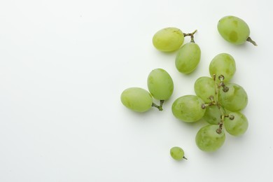 Fresh grapes on white background, top view. Space for text