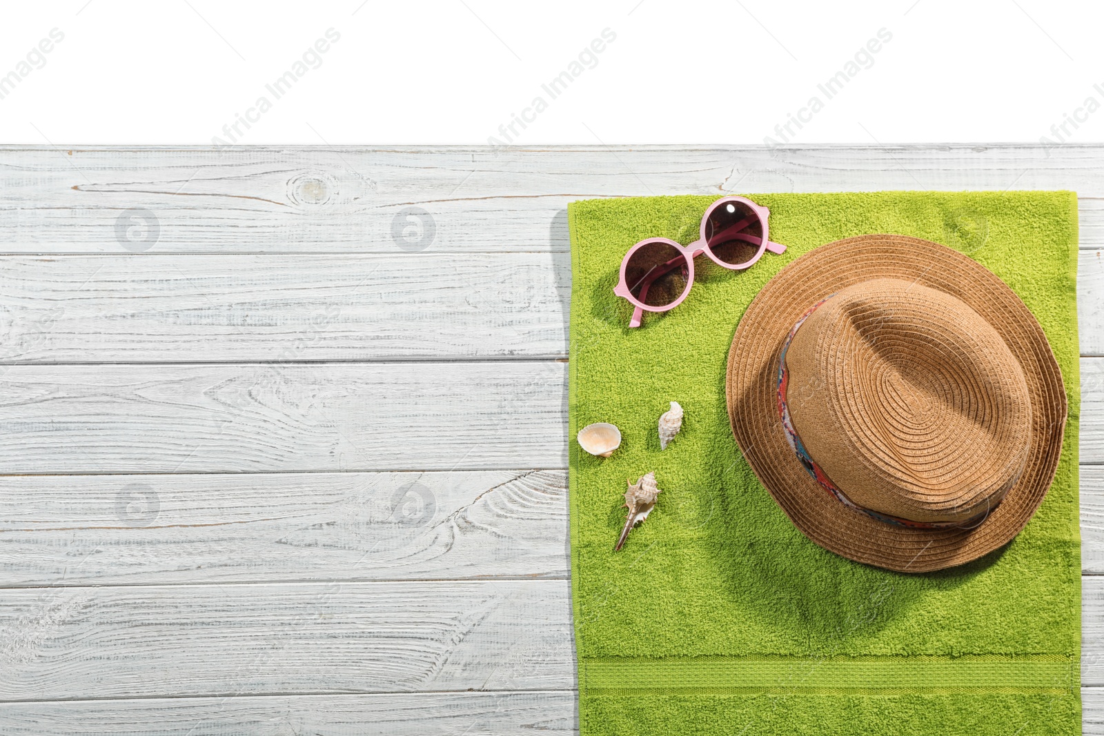 Photo of Flat lay composition with beach accessories on wooden background. Space for text