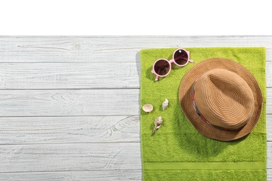 Photo of Flat lay composition with beach accessories on wooden background. Space for text