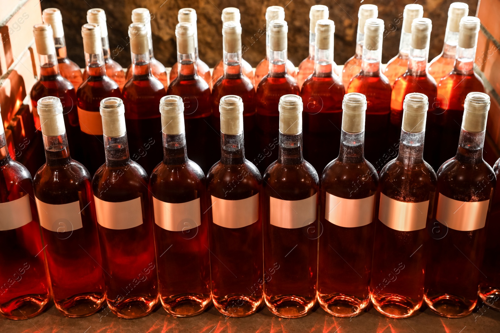 Photo of Many bottles of red wine on shelf, closeup