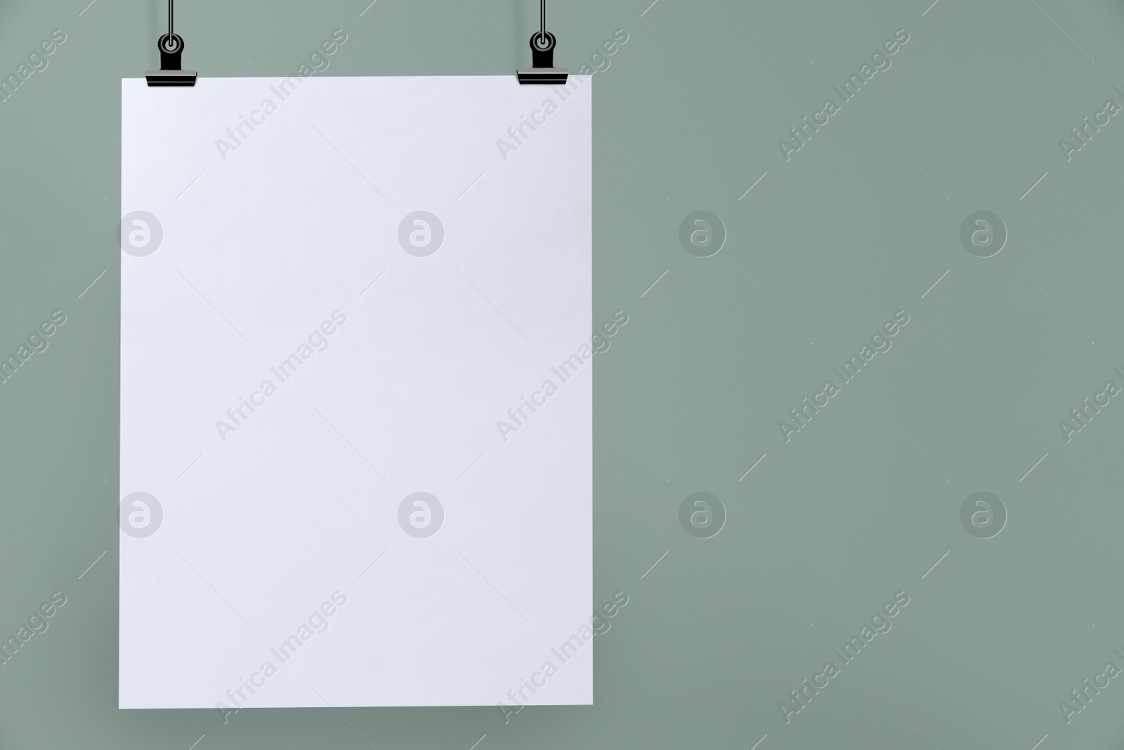 Image of Blank poster hanging near grey wall. Space for design