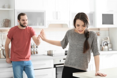 Photo of Young couple having argument in kitchen
