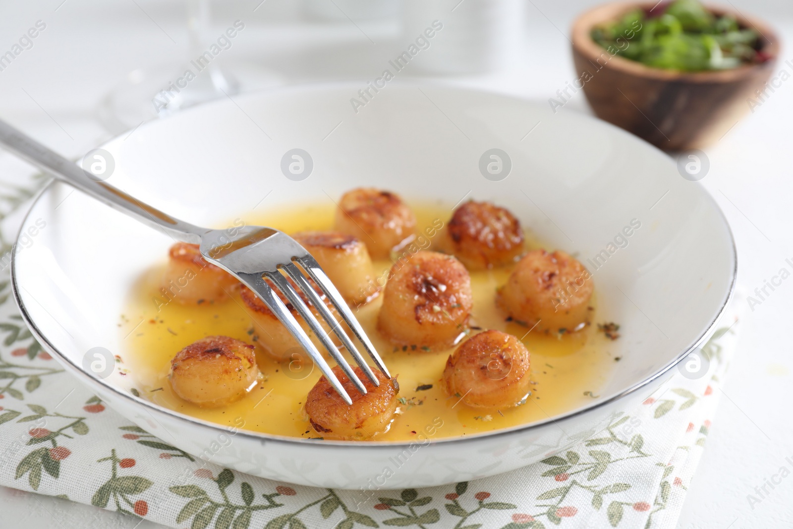 Photo of Delicious fried scallops served on white table