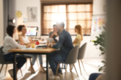 Image of Blurred view of professional interior designers working in office