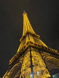 Beautiful illuminated Eiffel tower against night sky, low angle view