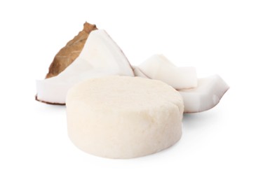 Photo of Solid shampoo bar and coconut pieces on white background. Hair care