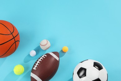 Many different sports balls on light blue background, flat lay. Space for text