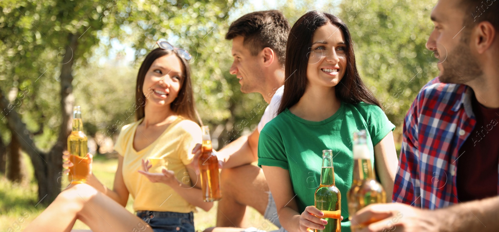 Image of Young people enjoying picnic in park on summer day. Banner design