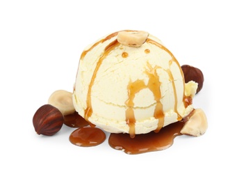 Photo of Delicious ice cream with caramel sauce and hazelnuts on white background