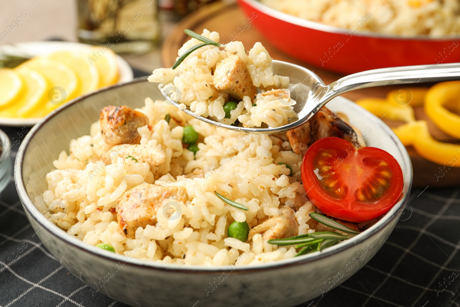 Photo of Delicious chicken risotto with tomato on table, closeup