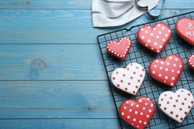 Photo of Heart shaped cookies on blue wooden table, flat lay. Space for text. Valentine's day treat