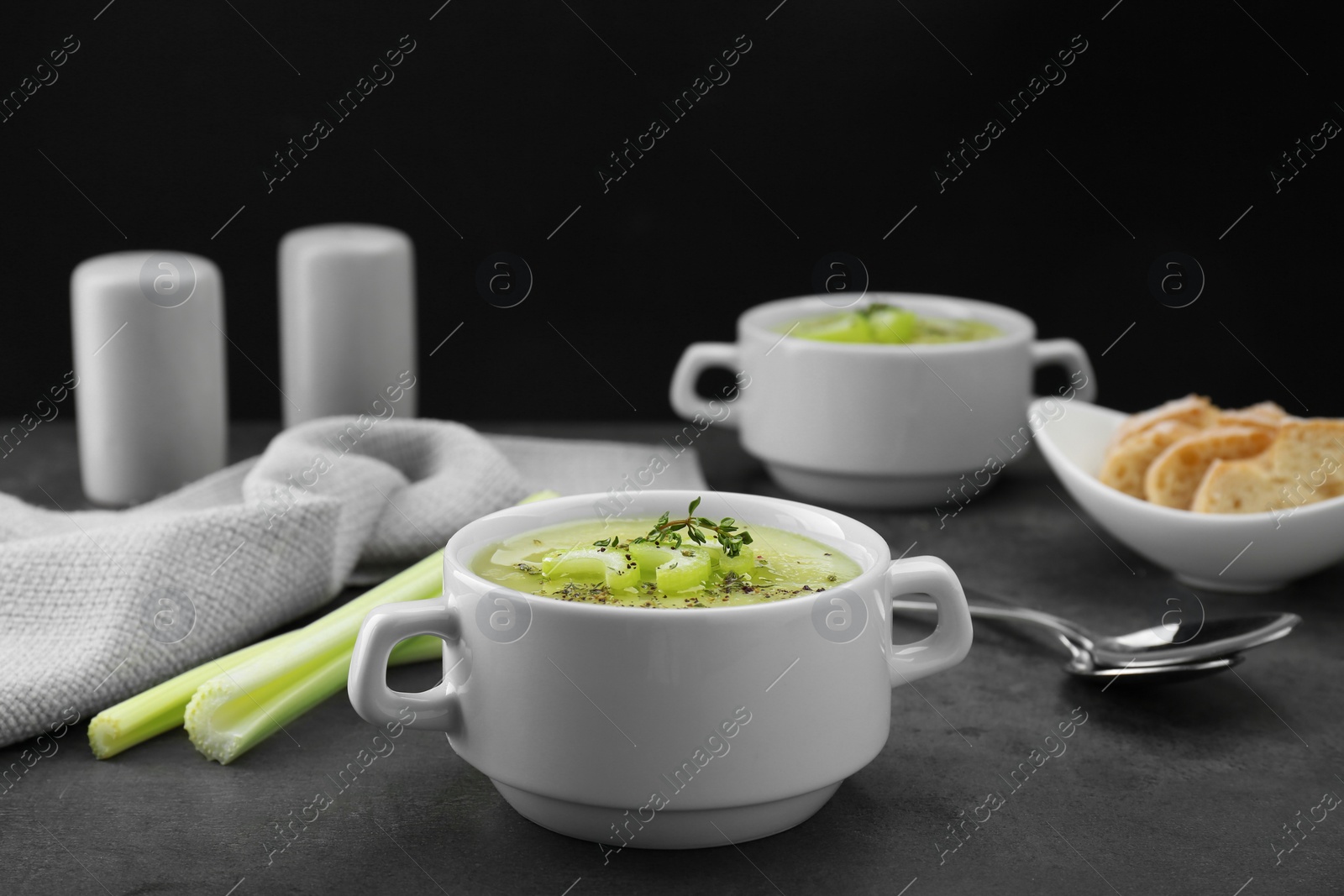 Photo of Delicious celery soup served on gray table