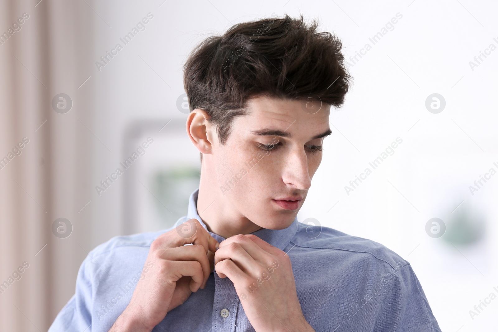 Photo of Portrait of young man with beautiful hair indoors