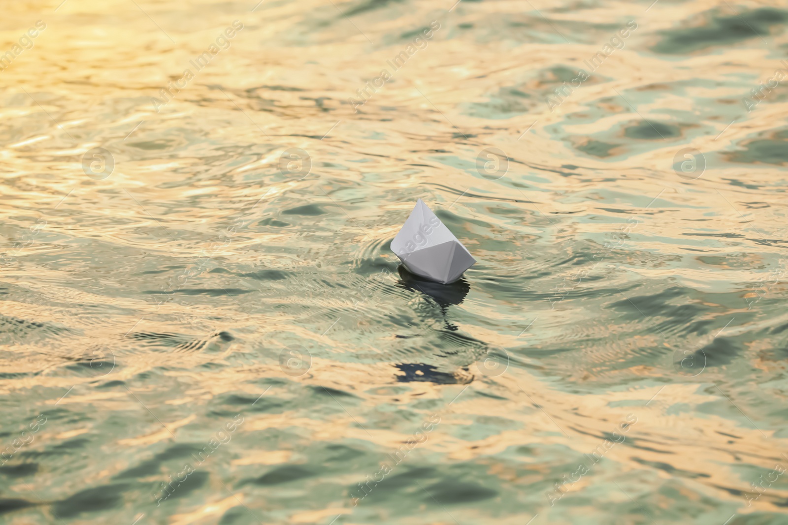 Photo of Paper boat floating on water outdoors. Space for text