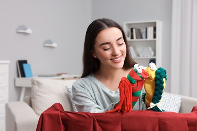 Photo of Happy woman performing puppet show at home