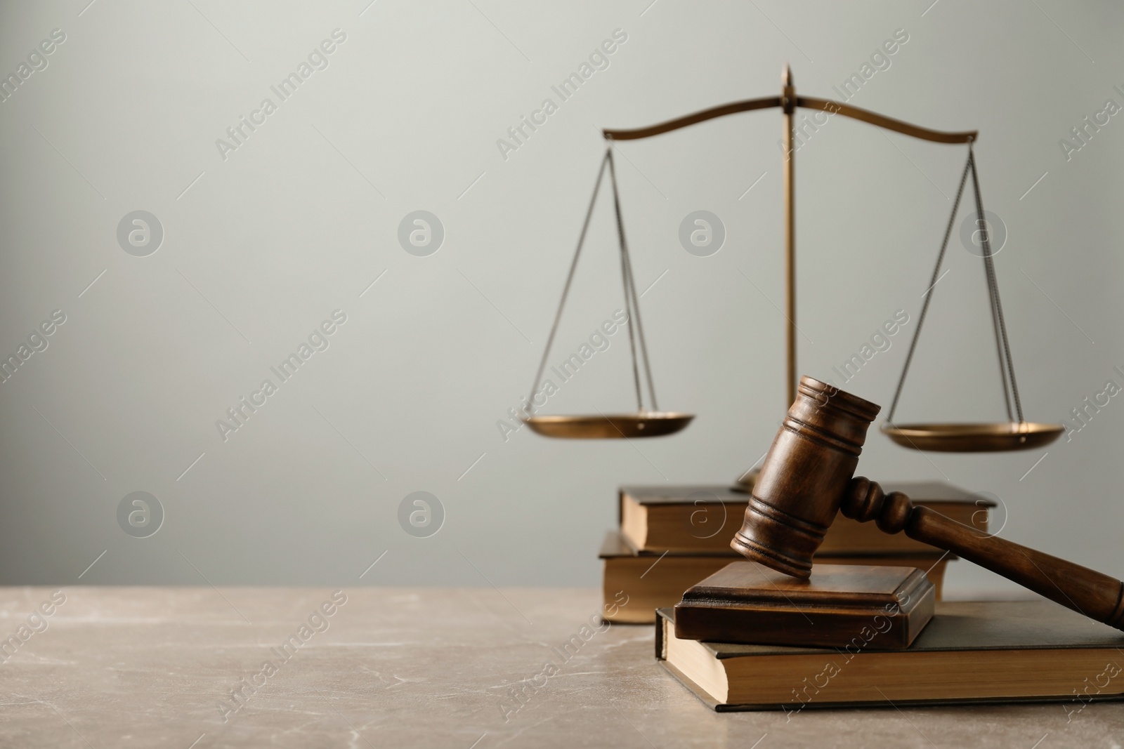 Photo of Wooden gavel with scales of justice and books on table. Law concept