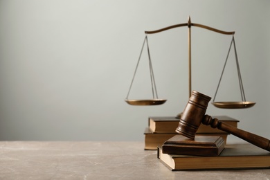 Wooden gavel with scales of justice and books on table. Law concept