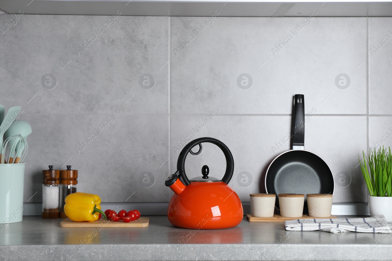 Photo of Set of different cooking utensils and products on grey countertop in kitchen