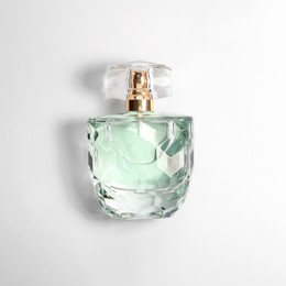 Photo of Luxury women's perfume in bottle on white background, top view