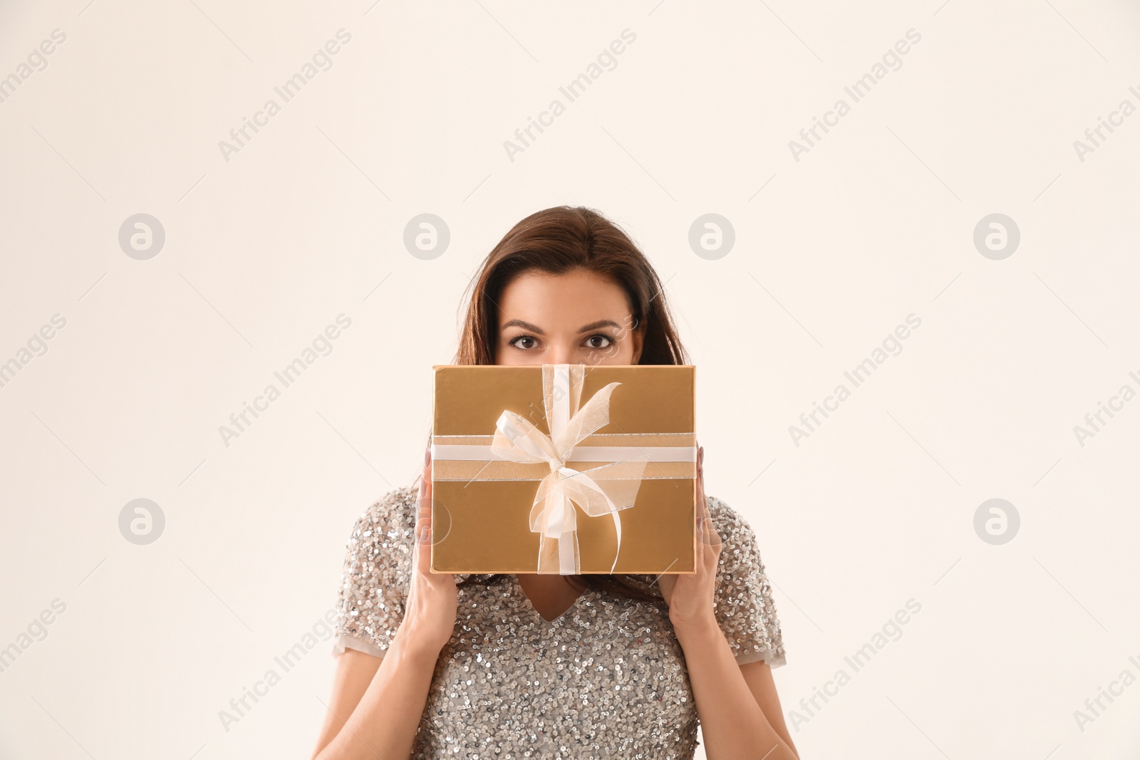 Photo of Beautiful woman with Christmas gift on white background