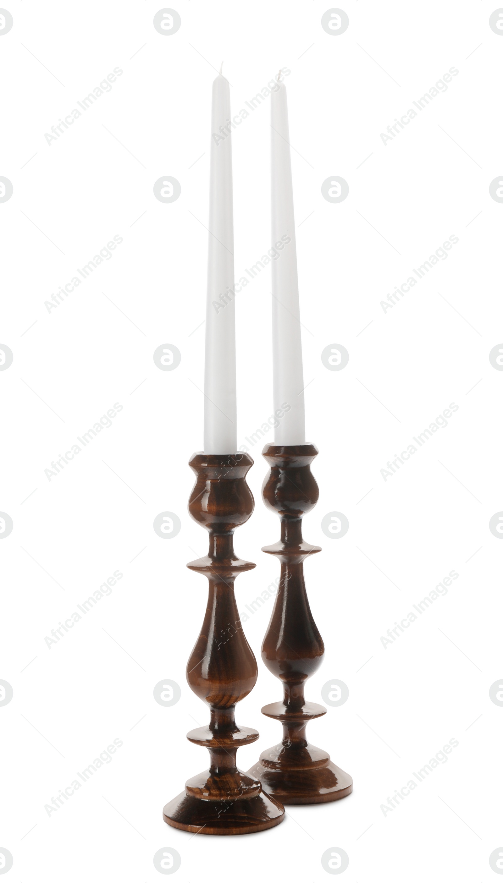 Photo of Elegant candlesticks with candles on white background