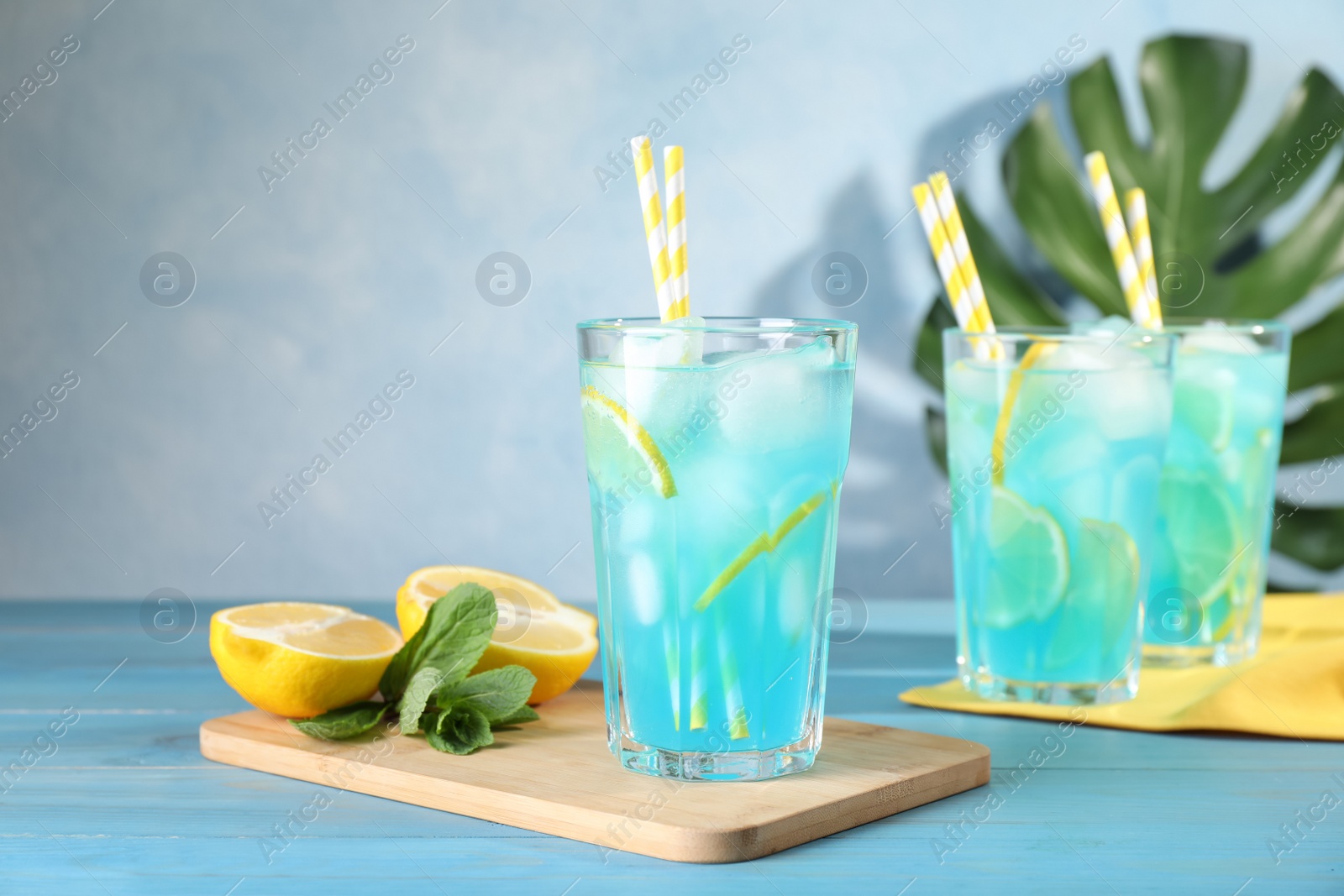 Photo of Delicious refreshing cocktail with ice on wooden table