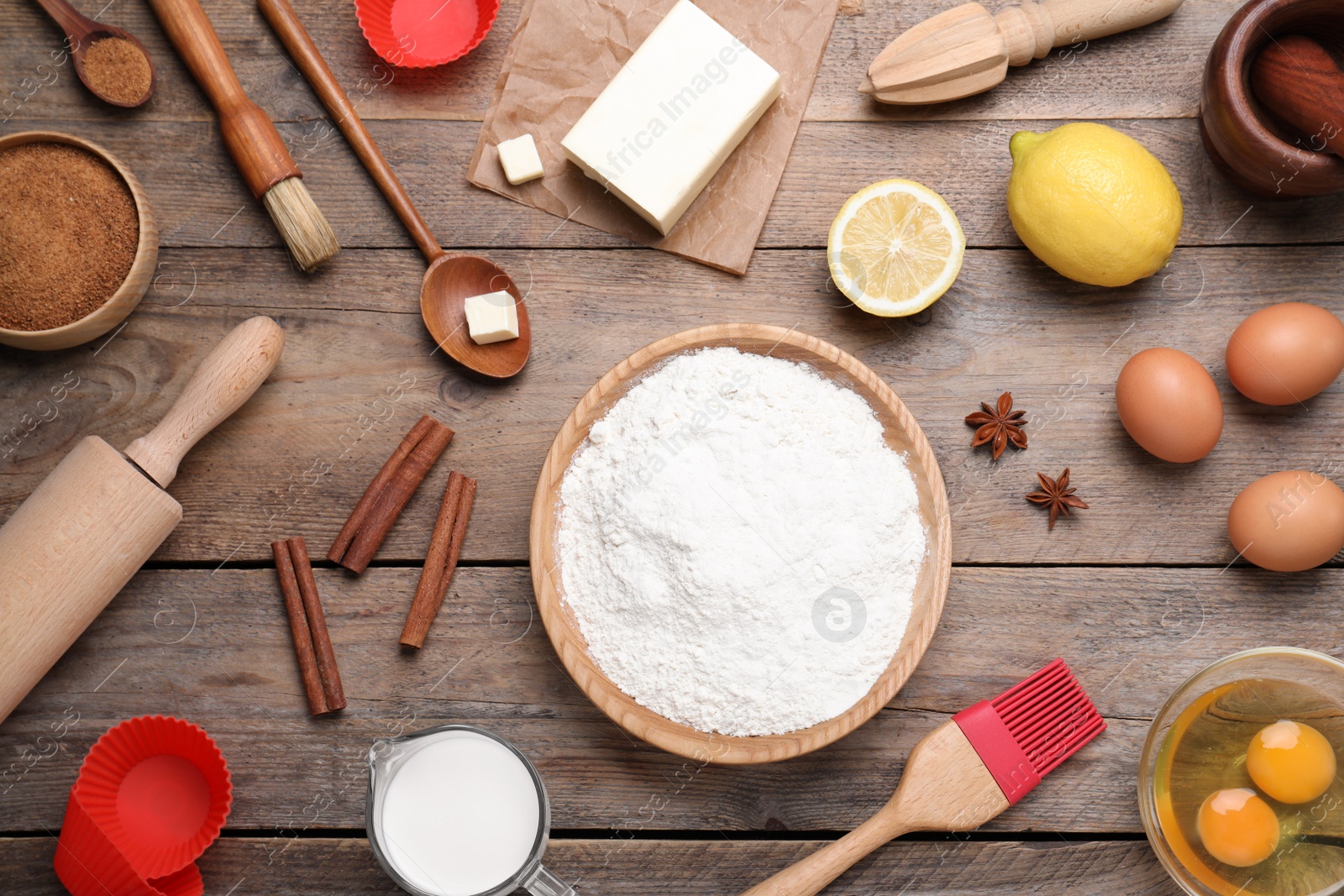 Photo of Cooking utensils and ingredients on wooden table, flat lay