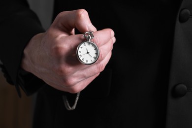 Man holding chain with elegant pocket watch, closeup