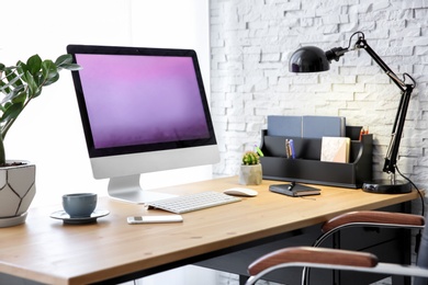 Photo of Stylish workplace with computer on table