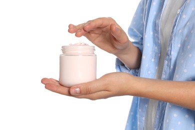 Woman taking hand cream from jar against white background, closeup