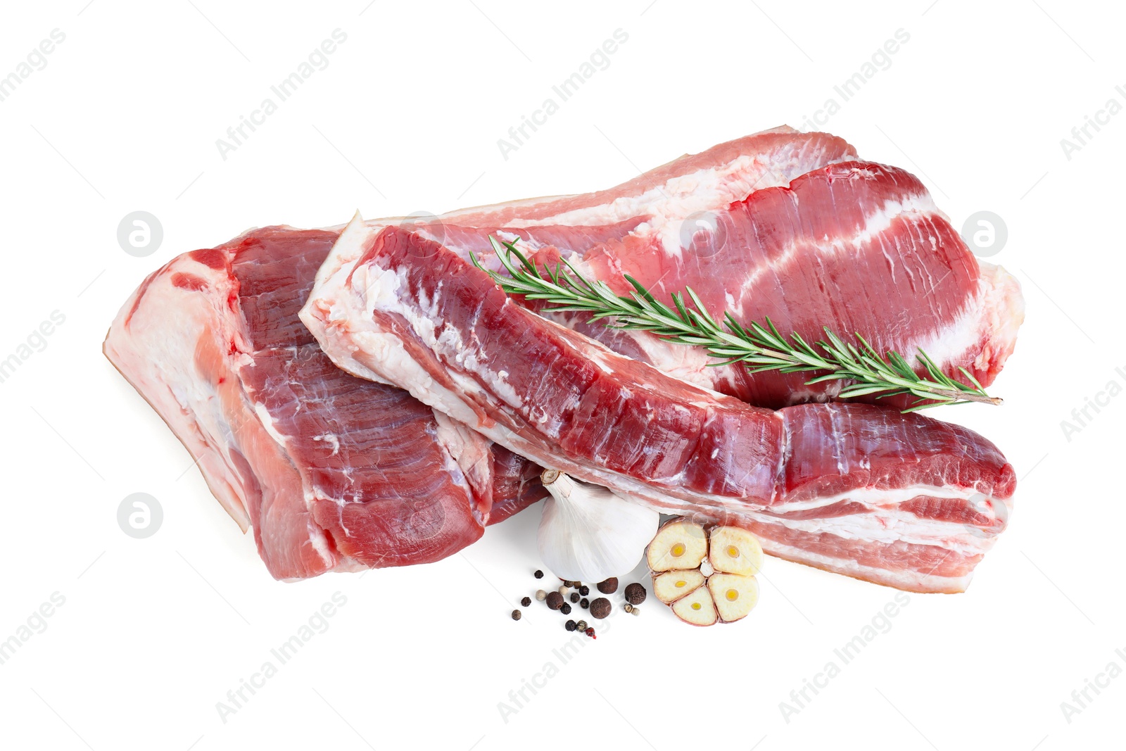 Photo of Pieces of raw pork belly, garlic, rosemary and peppercorns isolated on white, above view