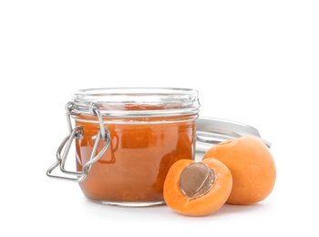 Photo of Jar with delicious apricot jam and fruit on white background