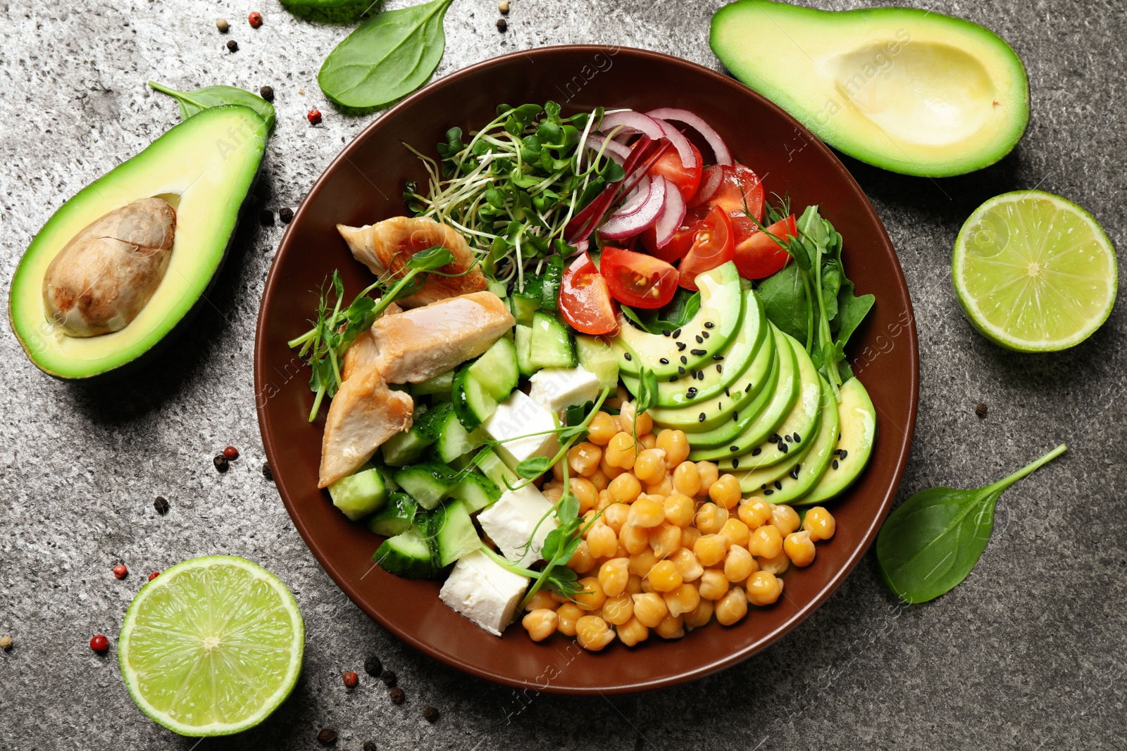 Photo of Delicious avocado salad with chickpea on grey table, flat lay