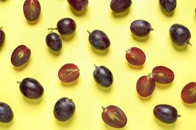 Flat lay composition with fresh ripe juicy grapes on yellow background