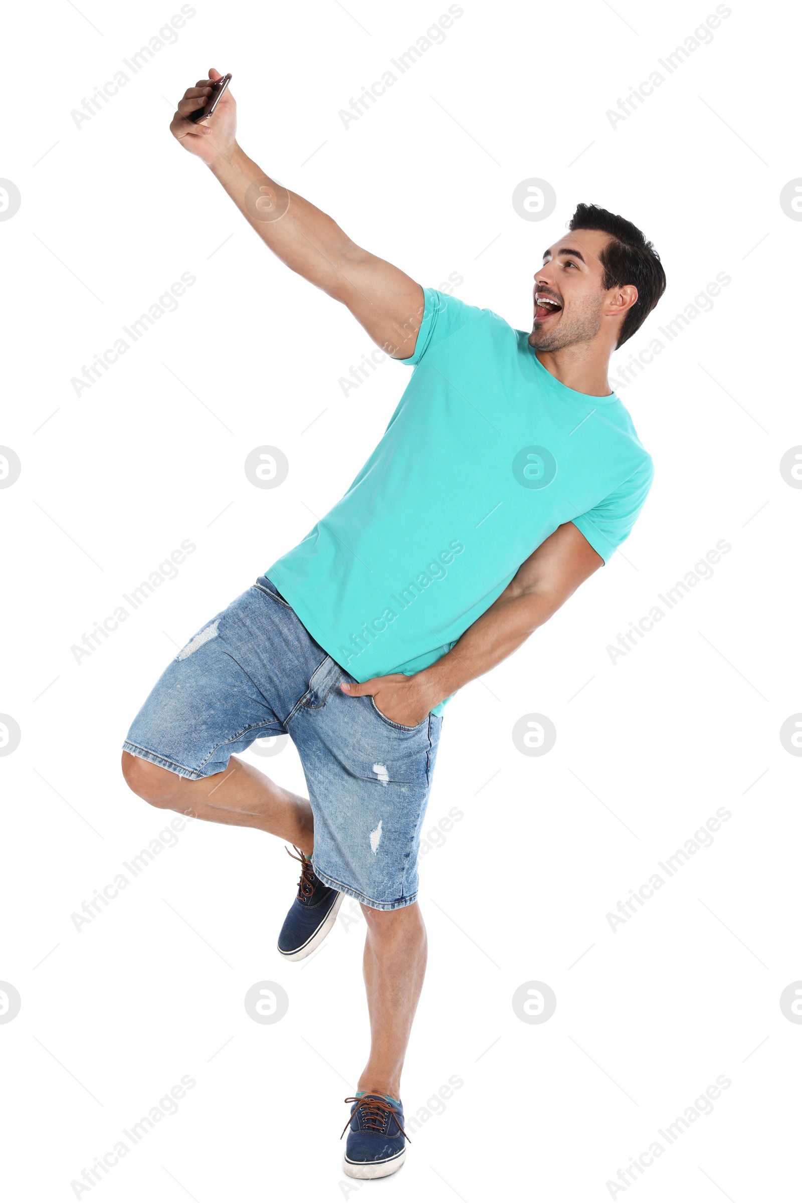 Photo of Happy young man taking selfie on white background