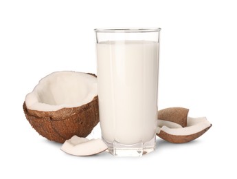 Photo of Glass of delicious vegan milk and coconut pieces on white background