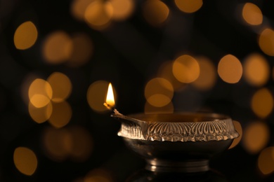 Diwali diya or clay lamp against blurred lights