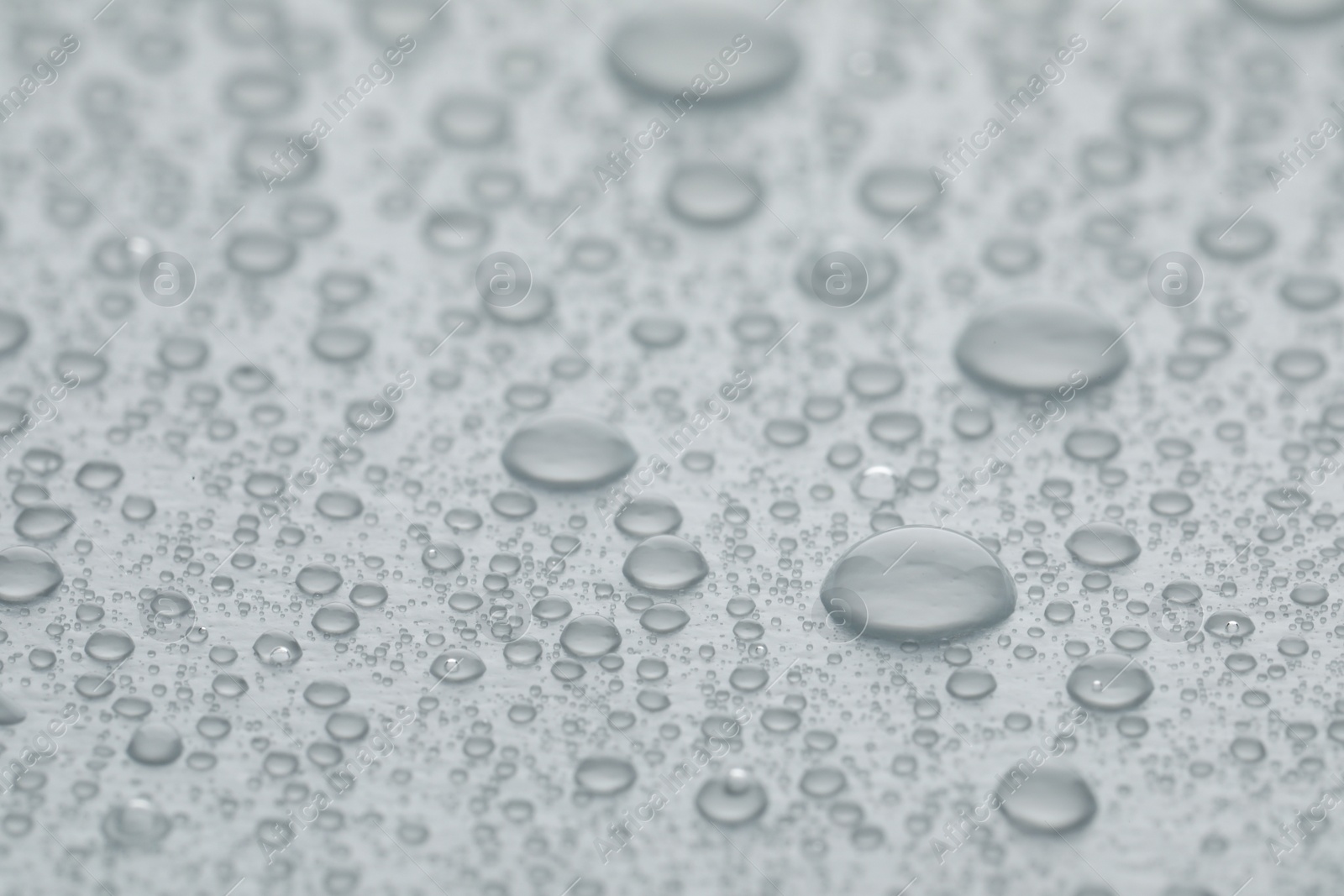 Photo of Water drops on white background, closeup view