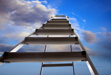 Image of Metal stepladder against blue sky with clouds, low angle view