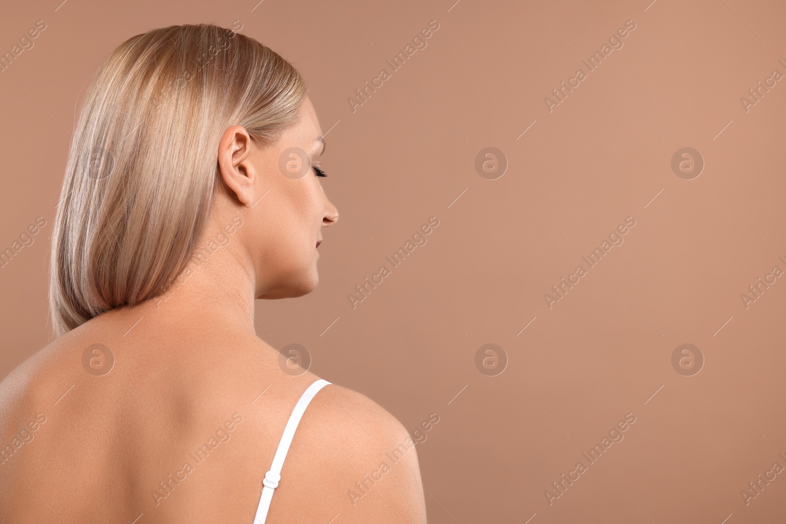 Photo of Beautiful woman with healthy skin on beige background. Space for text