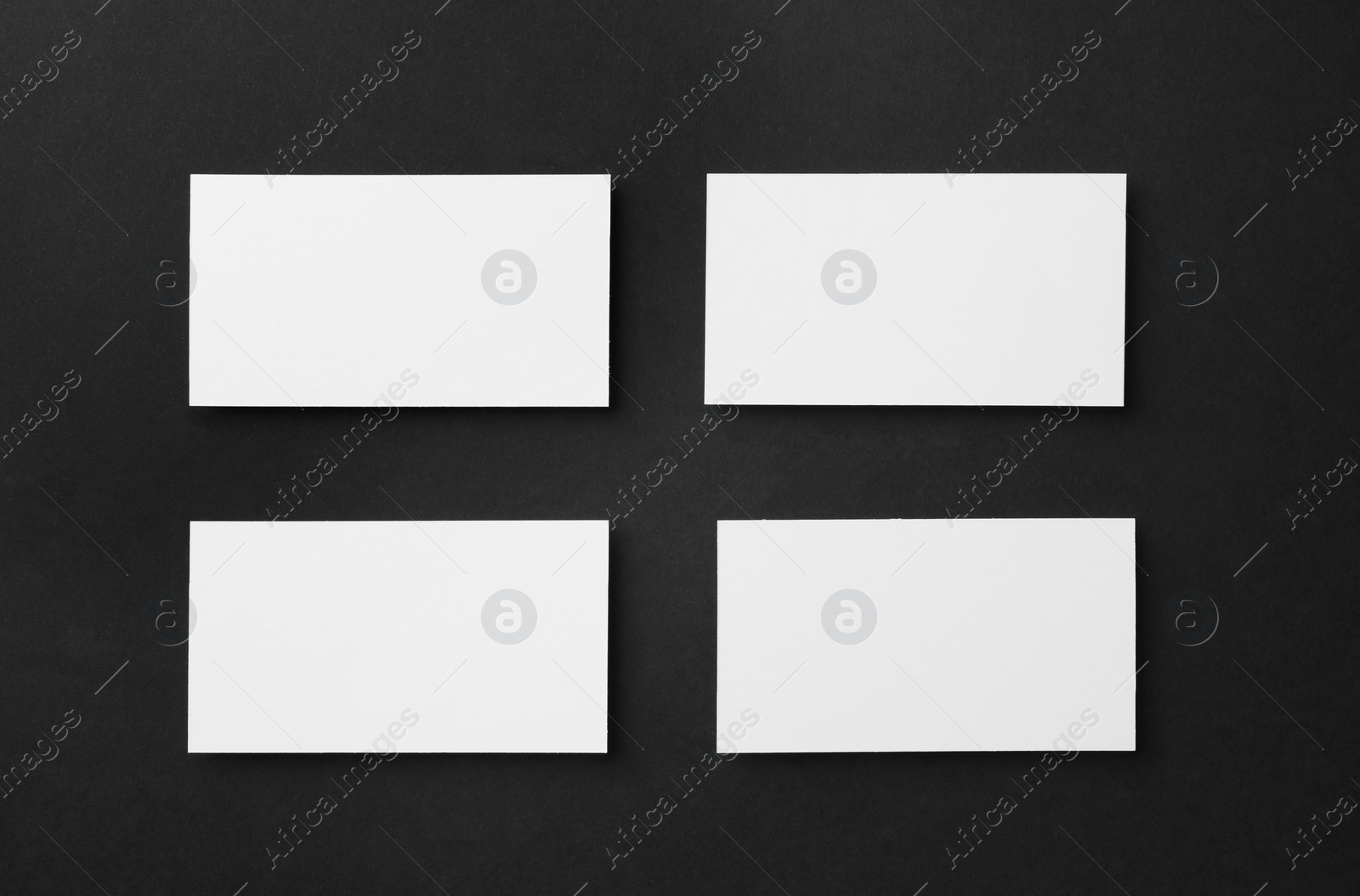 Photo of Blank business cards on black background, flat lay. Mockup for design