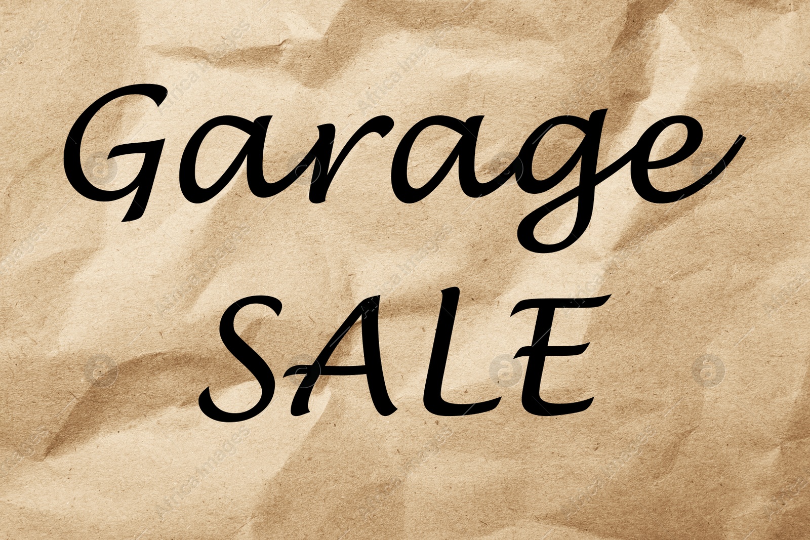 Image of Phrase GARAGE SALE written on brown crumpled paper 