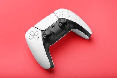 Photo of One wireless game controller on red background