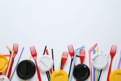 Photo of Plastic dishware on white background, flat lay. Space for text