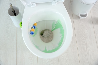 Ceramic toilet bowl with detergent in modern bathroom